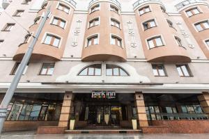 a large building with a sign on the front of it at Park Inn by Radisson Sadu in Moscow