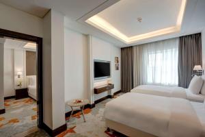 A bed or beds in a room at Radisson Blu Hotel, Ajman