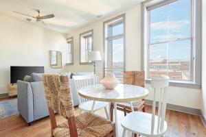 a living room with a table and chairs and a couch at Sonder Telfair Square in Savannah