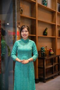 
a young woman standing in front of a display case at Oriana Boutique Hotel & Spa in Hanoi

