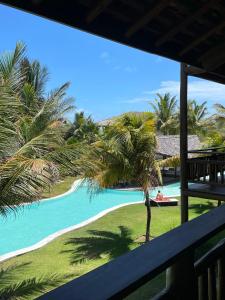 a view from the balcony of a resort with a palm tree at App Lory KiteVillage in Uruau