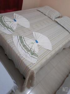 two white beds with umbrellas on top of them at POUSADA ROTA DAS ÁGUAS in São Félix do Tocantins