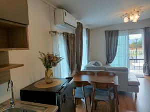 a kitchen and living room with a couch and a table at Khaoyaitriplefive in Ban Thung Sawang