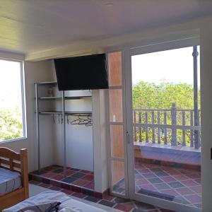 a living room with a television and a balcony at BONANZA in Monterrey