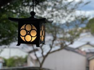 a black lantern hanging from a street light at KIYOMORI in Hatsukaichi