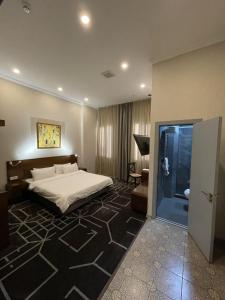 a bedroom with a bed and a room with a door at City Centre Hotel in Tashkent