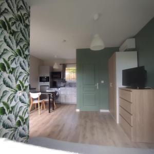 a living room with a kitchen and a dining room at maison aubenas le lavandin in Ucel