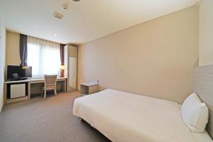 Postel nebo postele na pokoji v ubytování Chisun Hotel Kamata