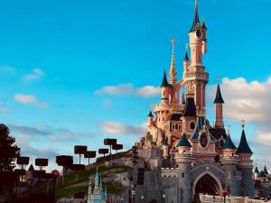 a disney castle on top of a hill at Bel appartement « The Lion King » proche Disney in Montévrain