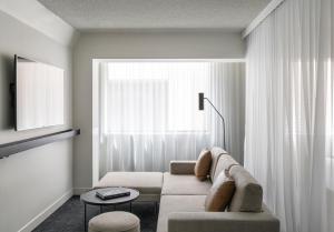 a living room with a couch and a window at Lancemore Crossley St. Melbourne in Melbourne +72 photos