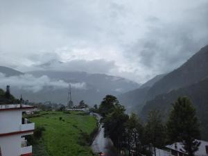 a view of a river in a valley with mountains at Hotel Ajay Palace in Pīpalkoti
