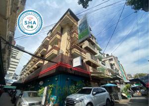 a building with a car parked in front of it at Arawana Express Chinatown in Bangkok