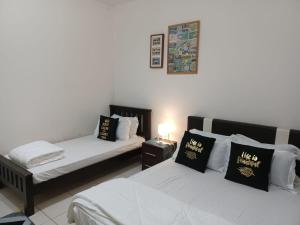 En eller flere senge i et værelse på Indah Alam Condo