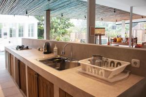 a kitchen with a sink and a counter top at Villa Rone By The Villas 100 in Bogor
