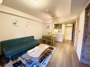 a living room with a green couch and a table at Akasaka Residence in Tokyo