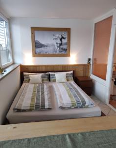 a bedroom with a bed with a cow picture on the wall at PenthouseApartment 250° in Sonthofen