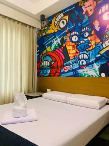 1 dormitorio con una pintura en la pared en Sultana Ysabella Hotel and Event en Manila