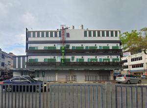 a building with a car parked in front of it at Kapit Hotel in Kuching
