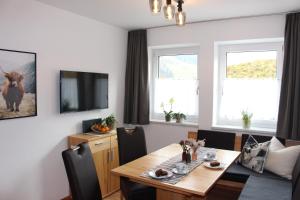 a dining room with a table and a television at Haus Lorenz in Schladming