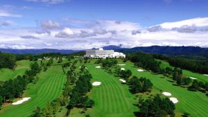 an aerial view of a golf course with a resort at Satsuma Resort Hotel in Satsuma