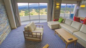 a living room with a couch and a table at Satsuma Resort Hotel in Satsuma