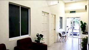 a living room with a large window and chairs at Ozzy Lodge Semporna in Semporna +26 photos