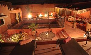 a room with a table and chairs and a balcony at riad Cala Medina in Marrakesh