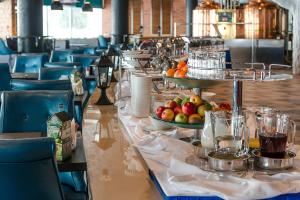 a long table with plates of fruit on it at Mirage Hotel in Kazan