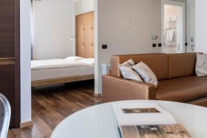 un soggiorno con un divano e un tavolo di APPARTAMENTI CAPRI MALCESINE a Malcesine