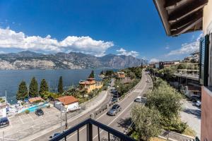 balcone con vista sulla città e sull'acqua. di APPARTAMENTI CAPRI MALCESINE a Malcesine