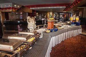 a buffet line with food on it in a restaurant at Hotel Cervantes in Guadalajara