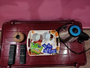 a tray of food on a table with a lamp at Anjana Palace in Digha