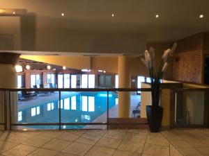 a swimming pool in a building with a vase of flowers at Duplex - 4 personnes ARC 1950 in Arc 1950
