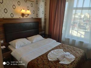 Postel nebo postele na pokoji v ubytování Hotel Bazaar