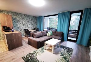 - un salon avec un canapé et une table dans l'établissement Apartments Golfhof, à Winterberg