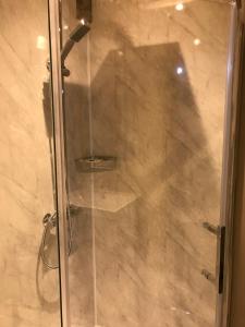 a shower with a glass door in a bathroom at Bridge Cottage in Cowling +8 photos