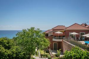 a house with a view of the ocean at Crystal Palace - Vista in Skala Kefalonias