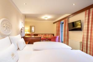 Postel nebo postele na pokoji v ubytování Hotel Bräu