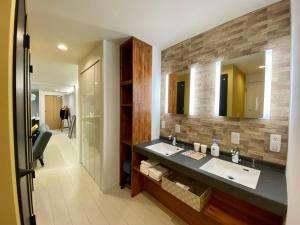 a bathroom with a sink and a mirror at Villa Monica in Nagoya