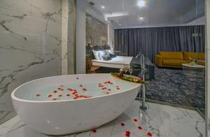 a bathroom with a bath tub with red hearts on the floor at Hotel Wiki Sanok Events & Bowling in Sanok