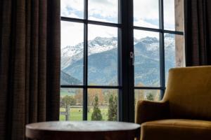 a room with a window with a view of mountains at Tauernlodges Uttendorf by ALPS RESORTS in Uttendorf