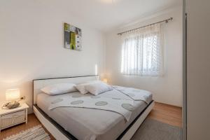 Postel nebo postele na pokoji v ubytování Apartments Roje