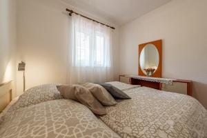 Postel nebo postele na pokoji v ubytování Apartments Roje