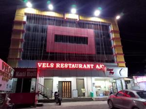 a building with a sign that reads wells restaurant authorityagency at Vels Residency in Puducherry