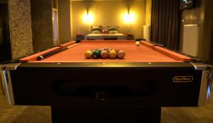 a pool table with balls on top of it at LE LOFT A BULLES (85m2 Jacuzzi Hammam Billiard Bar Douche Sauna) in Strasbourg