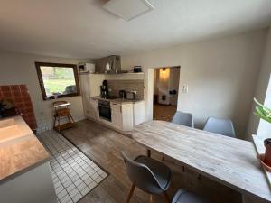 une cuisine et un salon avec une table et des chaises dans l'établissement 300 Jahre altes renoviertes Fachwerkhaus, à Peterslahr