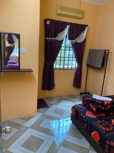 a room with a bed and a window at PJM HILL VIEW HOMESTAY in Ipoh