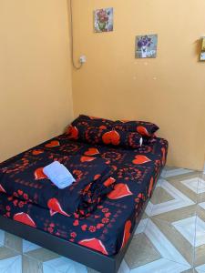 a small bedroom with a bed with a blue comforter at PJM HILL VIEW HOMESTAY in Ipoh