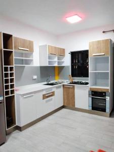 a large kitchen with white cabinets and a sink at Idyllic Villa in Pereybere with Private Pool in Pereybere