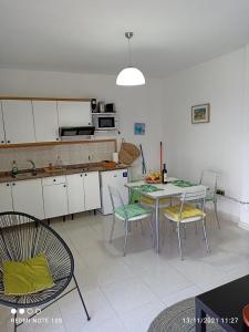 a kitchen with a table and chairs in a room at Apartamento El Carmen 6 in Morro del Jable +3 photos